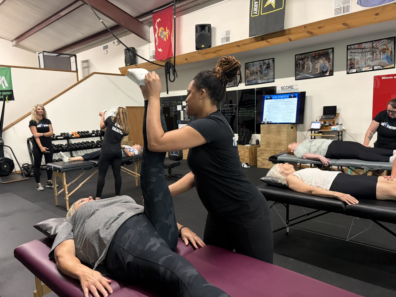 A Charged Rootz stretch session in progress inside the gym