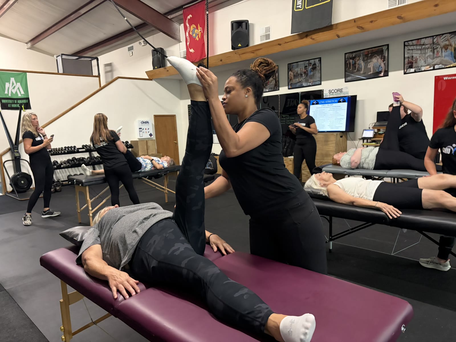 The stretch therapist guiding a client through a table stretch