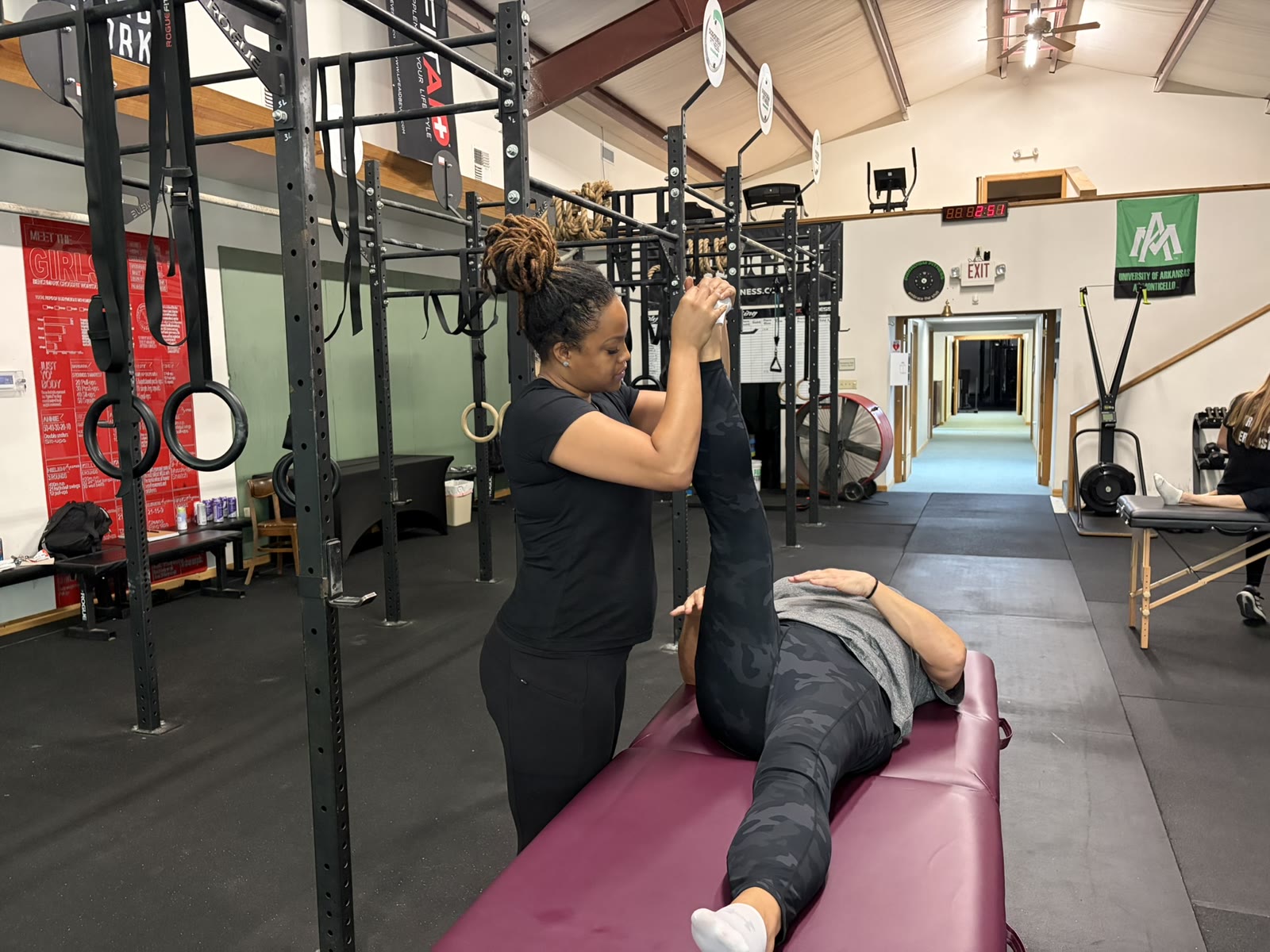 A stretch session with the therapist supporting a client on the table