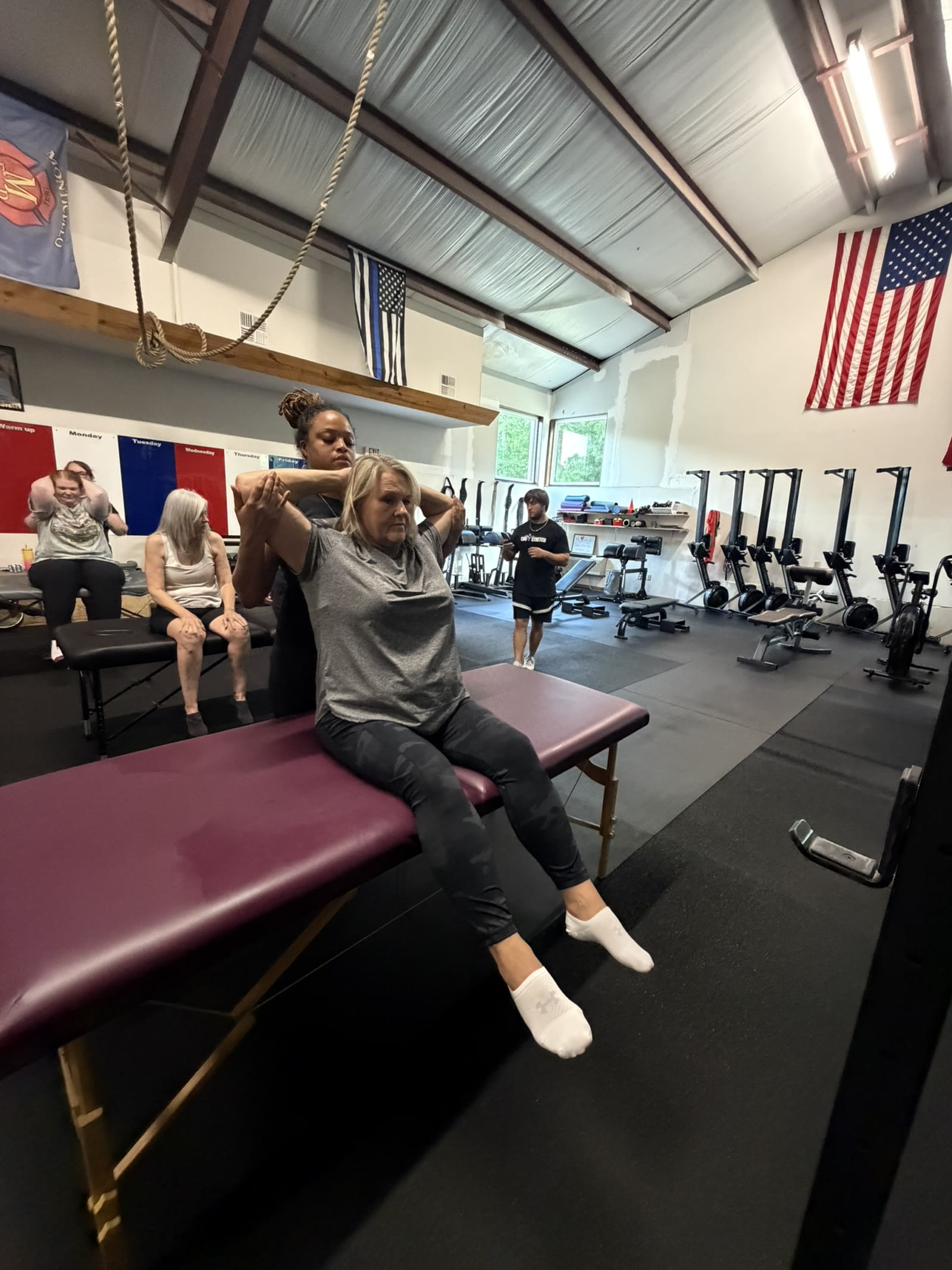 A client preparing for a shoulder stretch